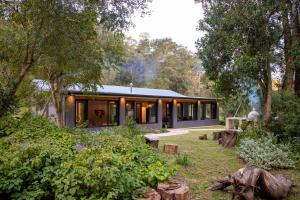 a house in the middle of a garden at Boshuis Farm Stay in George