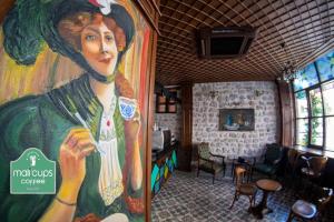 a large painting of a woman on the wall of a restaurant at Sam Franss Boutique Otel in Hatay
