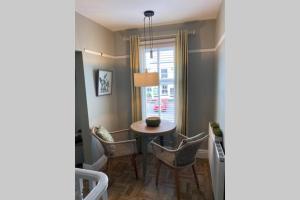 a dining room with a table and chairs and a window at Mayfield Apartment Luxury first floor 1 bedroom apartment in Great Eccleston