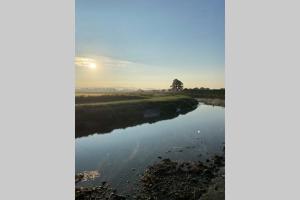 a river with the sun setting in the background at Mayfield Apartment Luxury first floor 1 bedroom apartment in Great Eccleston