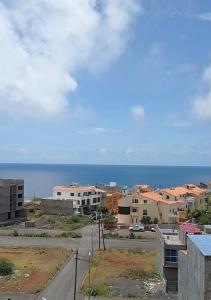 a view of a city with the ocean in the background at Apartamento Novo, Brand New Apartament T1, Cidadela, Praia, Cabo Verde in Praia