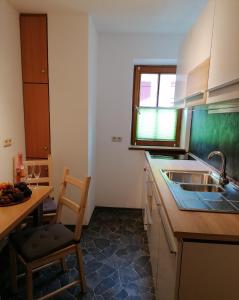 a kitchen with a sink and a counter top at Alpenstyle Ferienwohnung mit Südbalkon in Geisteier's Hüs in Bad Oberdorf