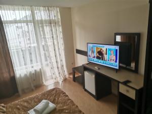 a living room with a flat screen tv and a couch at Pensiunea Eric in Iaşi