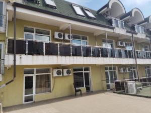 a building with a balcony with air conditioners on it at Pensiunea Eric in Iaşi