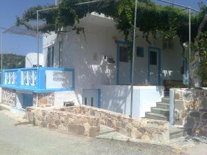 a house with a blue sign in front of it at Dionysia Studios in Kefalos