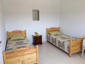 a bedroom with two beds and a night stand at Kélibia Paradise in Kelibia