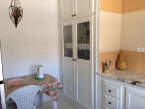 a kitchen with a counter and a white cabinet at Kélibia Paradise in Kelibia