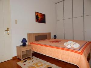 a bedroom with a large bed and a night stand at Cozy apartment for 2-5 people-Center Tripoli 1 in Tripoli