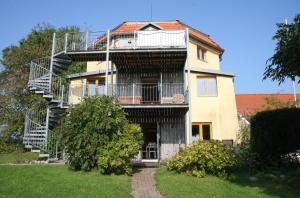 a house with a spiral staircase on the side of it at Alte Mühle Schleiblick in Maasholm