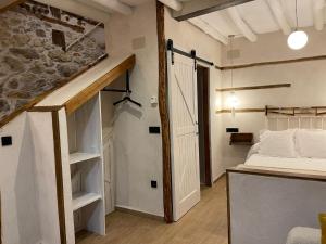 a small room with a bed and a staircase at Apartamento La Herrerita in Candelario