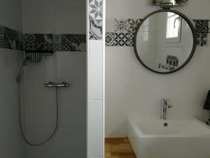 a bathroom with a shower and a sink and a mirror at Chambres d'hôtes Ferme du Feugrès in Saint Germain la campagne