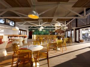a restaurant with tables and chairs in a room at Hard Rock Hotel Ibiza in Playa d'en Bossa