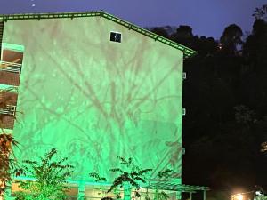 a large green screen on the side of a building at Apart Hotel Angra dos Reis II in Angra dos Reis