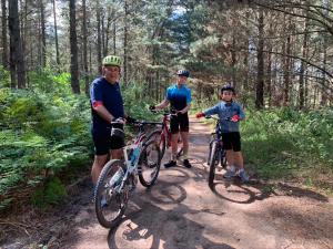 a group of people standing on a trail with bikes at Mountain Trails Accommodation in George