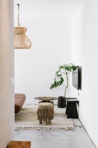 a living room with a table and a potted tree at AYA Boutique Aparthotel in Tel Aviv