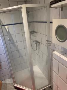 a shower with a glass door in a bathroom at Eifel Residence in Gerolstein +19 photos