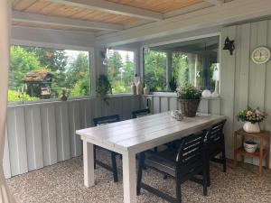a dining room with a white table and chairs at Eifel Residence in Gerolstein