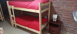 a couple of bunk beds in a room with a brick wall at Alojamiento para Grupos in Belén