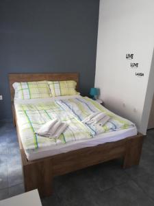 a bed with two pillows on top of it at Apartment by the Sea,Neoi Epivates Beach, Thessaloniki in Neoi Epivates