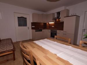 eine Küche mit einem großen Holztisch mit einer großen Matratze darauf in der Unterkunft Haus Francazi Sillian in Sillian