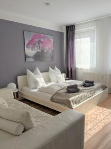 a bedroom with two beds and a white couch at Seerose in Görlitz