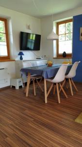 a dining room with a blue table and chairs at Tulpika1 in Moravske Toplice