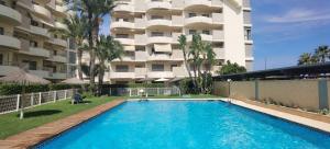 a swimming pool in front of a apartment building at sanluis in Daimuz