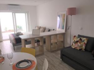 a living room with a table and a couch at Tomarhousing - Old Town in Tomar