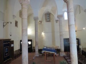 a room with columns and a table in a building at Tomarhousing - Old Town in Tomar