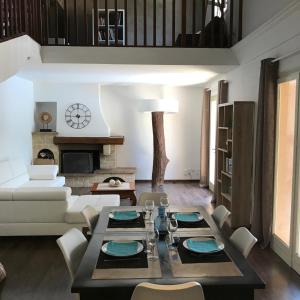 a living room with a table and a couch at Villa sur la Côte d’Azur avec piscine in La Colle-sur-Loup