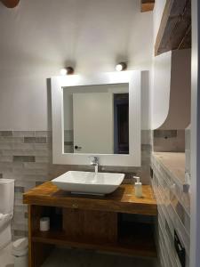 a bathroom with a sink and a mirror at Ca La Gràcia in Cabrianas