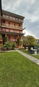 a building with a picnic table in a park at Casa Miralago in Menaggio