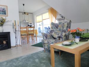 a living room with a chair and a table at Birkenstraße 15b Whg 13 in Zingst