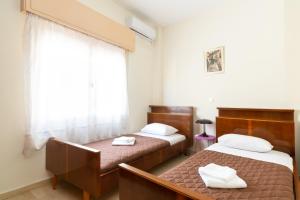 Postel nebo postele na pokoji v ubytování Aloe Apartments