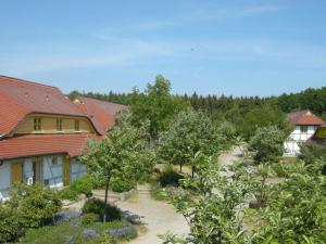 a garden in front of a house with trees at Ferienparadies Rugana D07 in Kreptitz