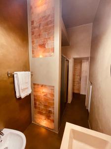 a bathroom with a sink and a brick wall at Casa Citta in Brescia