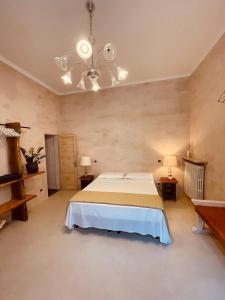 a large bedroom with a bed and a chandelier at Casa Citta in Brescia