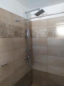 a bathroom with a shower with a glass door at Eleana Studios in Skiros +170 photos