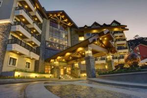 a large building with lights on it at night at Azalea Residences Baguio in Baguio