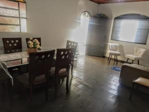 a living room with a dining room table and chairs at Casa 57 Temporada in Pirenópolis