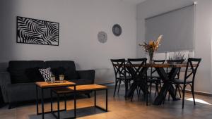 a living room with a couch and a table and chairs at Juana House in San Juan +8 photos
