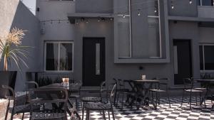 a restaurant with tables and chairs on a patio at Juana House in San Juan