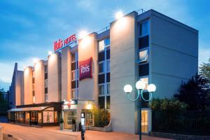 a hotel with a sign on the side of a building at ibis Paris Gennevilliers in Gennevilliers