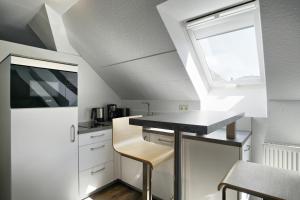 a kitchen with a counter and a sink and a window at Altes Wasserwerk, App 4 in Zingst