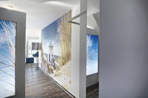 a hallway with a wall mural of a lighthouse at Altes Wasserwerk, App 4 in Zingst