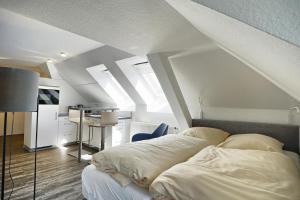 a bedroom with a bed and a desk in it at Altes Wasserwerk, App 4 in Zingst