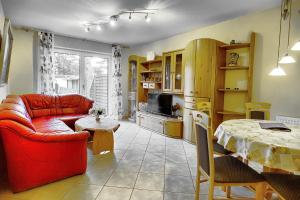 a living room with a red couch and a table at Hirschberger, Christian, FW 1 in Zingst