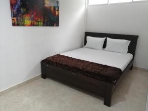 מיטה או מיטות בחדר ב-Hotel Sol del Estadio
