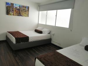 מיטה או מיטות בחדר ב-Hotel Sol del Estadio