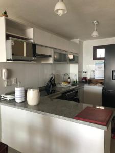 a kitchen with stainless steel appliances and a counter top at Departamentos Jardin del Mar IV Region, Chile in Coquimbo